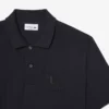 Petit Piqua-polo met klassieke pasvorm en geborduurde details