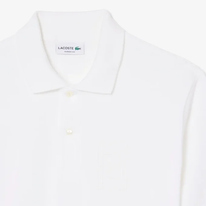 Petit Piqua-polo met klassieke pasvorm en geborduurde details