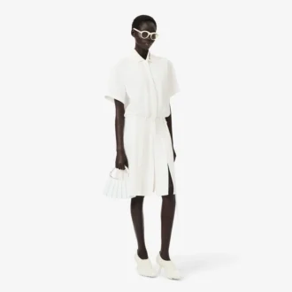 Runway-polojurk met plooien en borduursels
