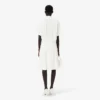 Runway-polojurk met plooien en borduursels