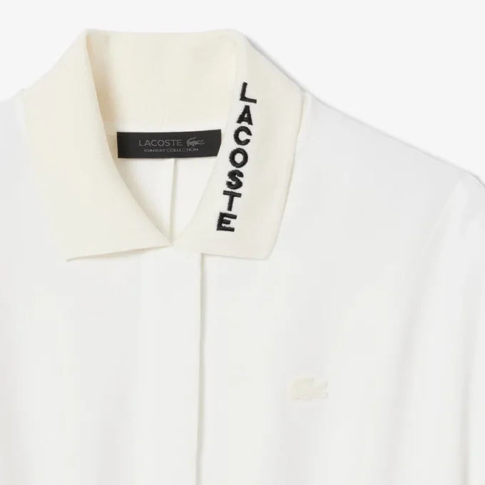 Runway-polojurk met plooien en borduursels