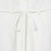 Runway-polojurk met plooien en borduursels