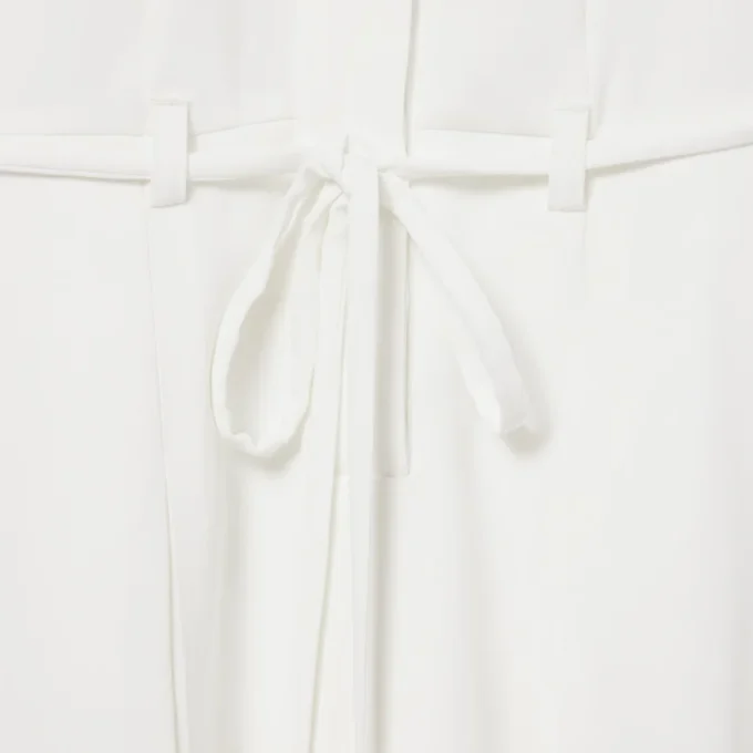 Runway-polojurk met plooien en borduursels